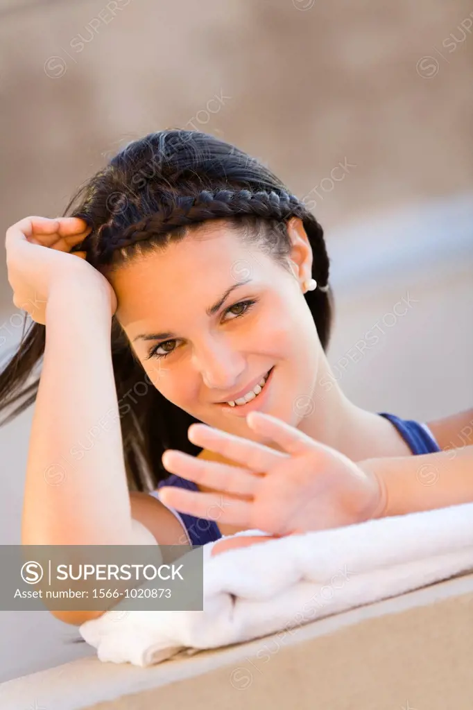 Pretty young woman is checking her nails