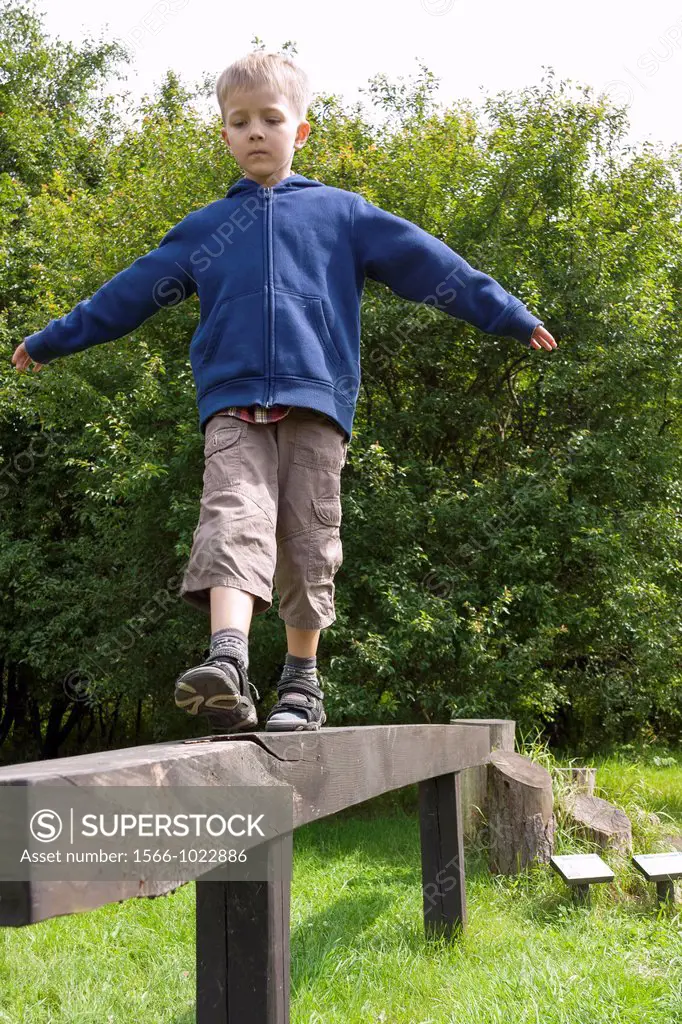 Boy practising on balance beam