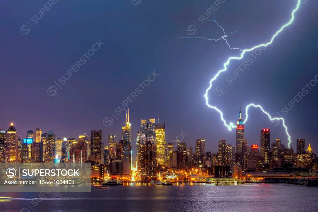 A large cloud to ground forked lightning bolt strikes the ground in New York City during a summer thunderstorm on Thursday, July 26, 2012