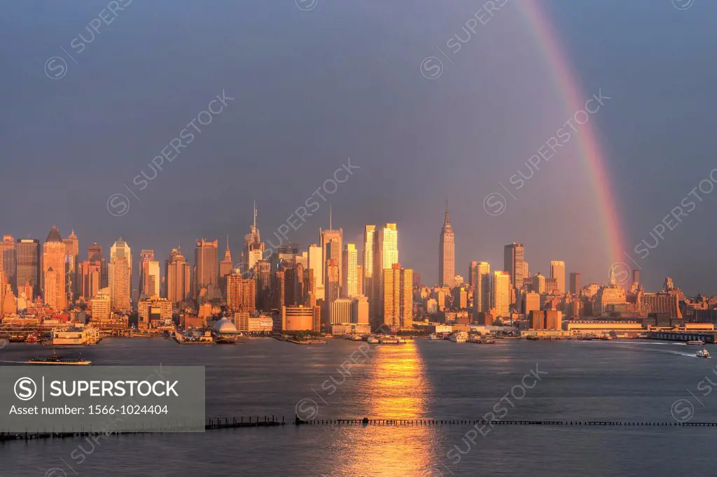 A rainbow appears over the Manhattan skyline in New York City shortly after a summer thunderstorm on Wednesday, August 15, 2012, as the setting sun re...