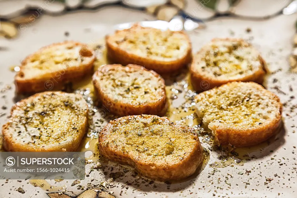 Sliced french bread with olive oil and spices