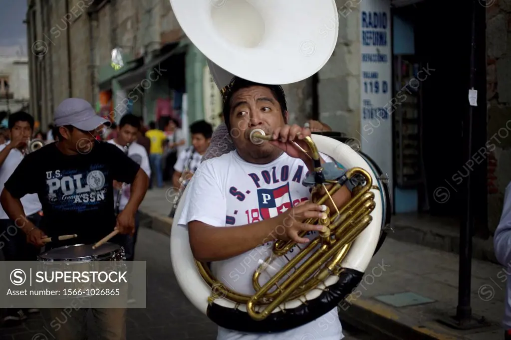 A man plays the tuba in a music band during the Convite of the Carmen Alto neighborhood, in Oaxaca, Mexico, July 12, 2012, in this tradition of the Ca...
