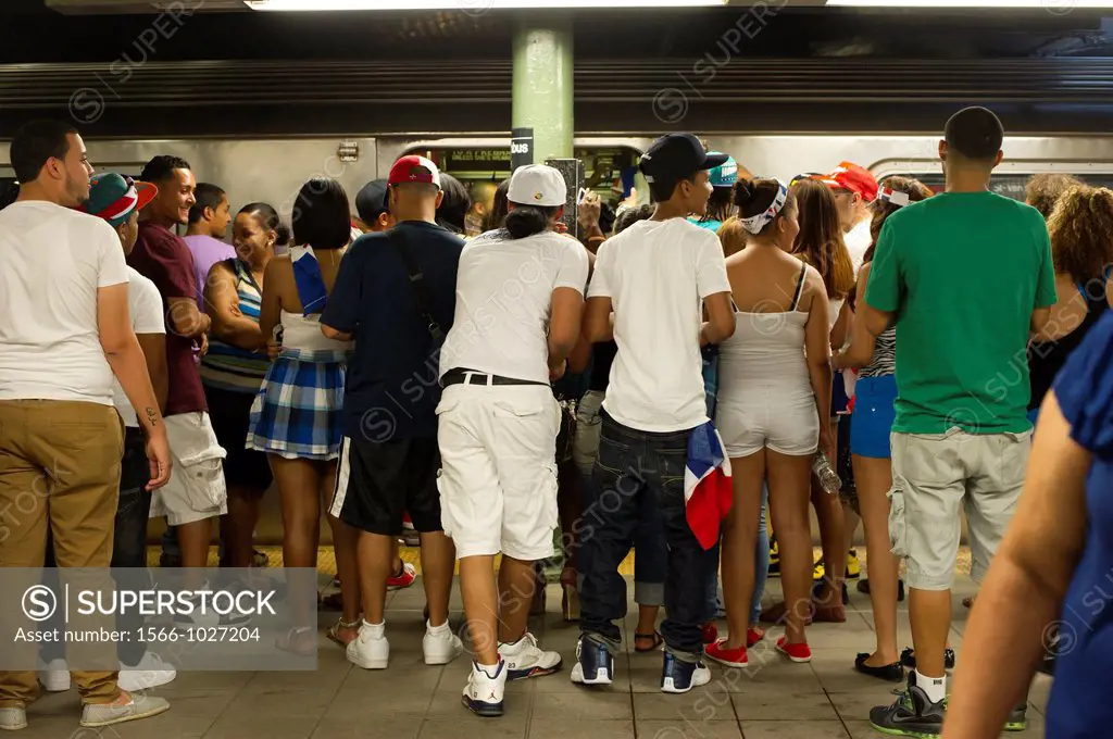 Revelers crowd the Number One subway train at the Columbus Circle station, traveling up to Washington Heights, after the Dominican Day parade in New Y...