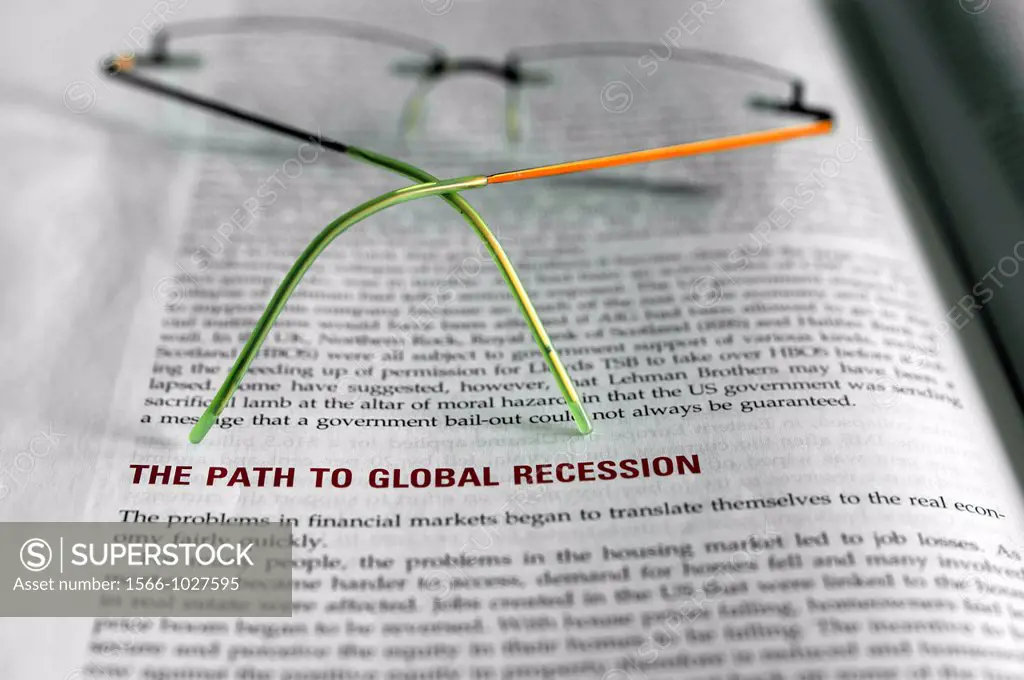 economy science book about global recession, with glasses on out of focus