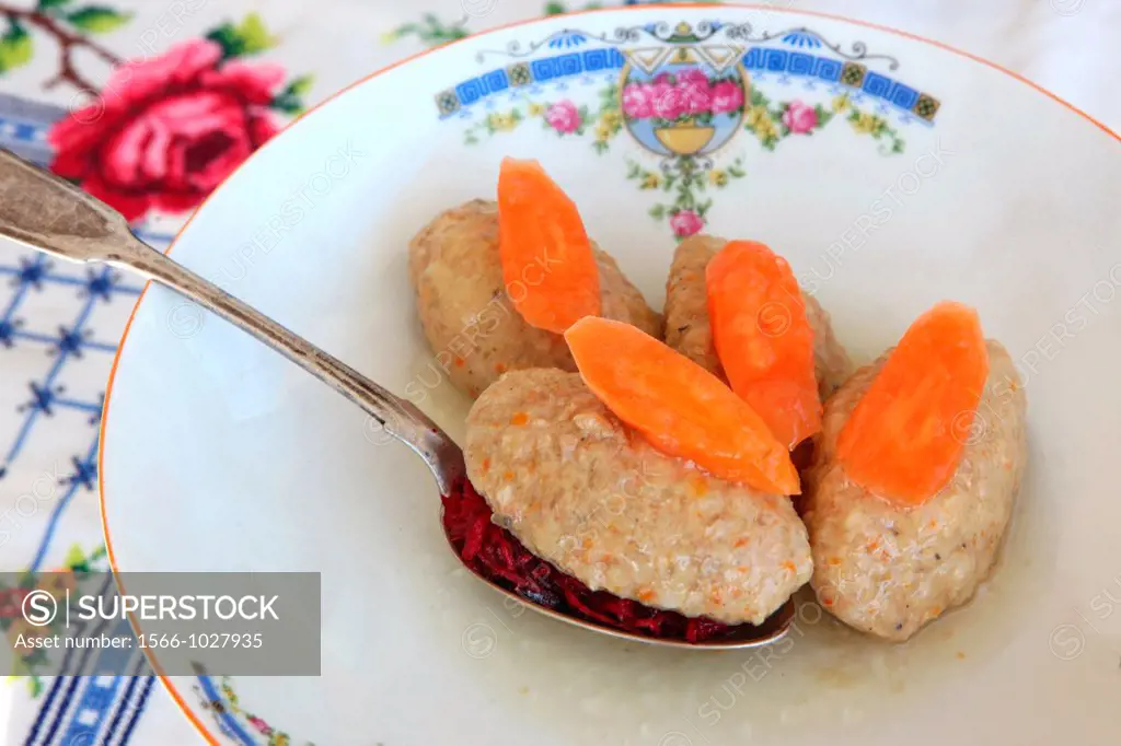 Gefilte fish with carrot  A traditional Askenazi Jewish festive dish of poached fish patties made from a mixture of ground deboned carp, traditionally...