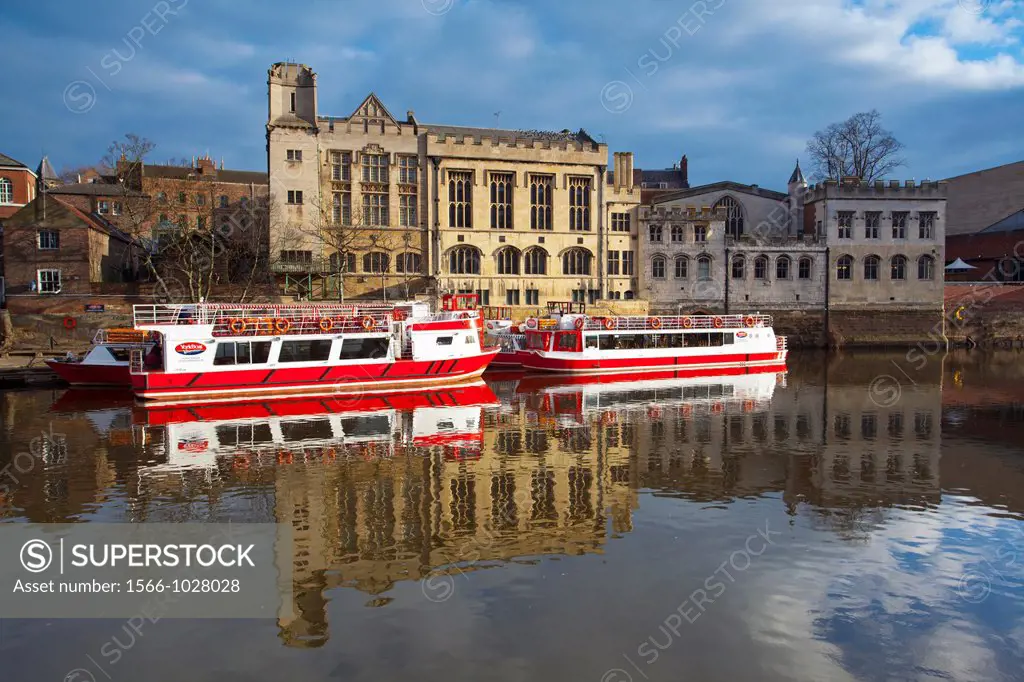 England, North Yorkshire, York City  York city river cruise boats moored on the River Ouse with the Guildhall in the Background