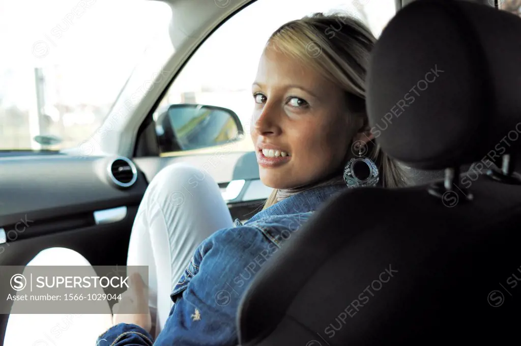 Blonde young woman in a car