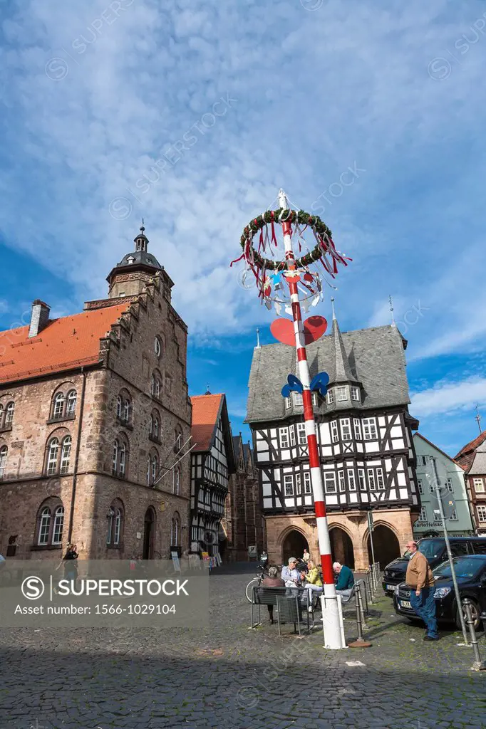 The picturesque market square with city hall, Walpurgiskirche and maypole in Alsfeld on the German Fairy Tale Route, Hesse, Germany, Europe