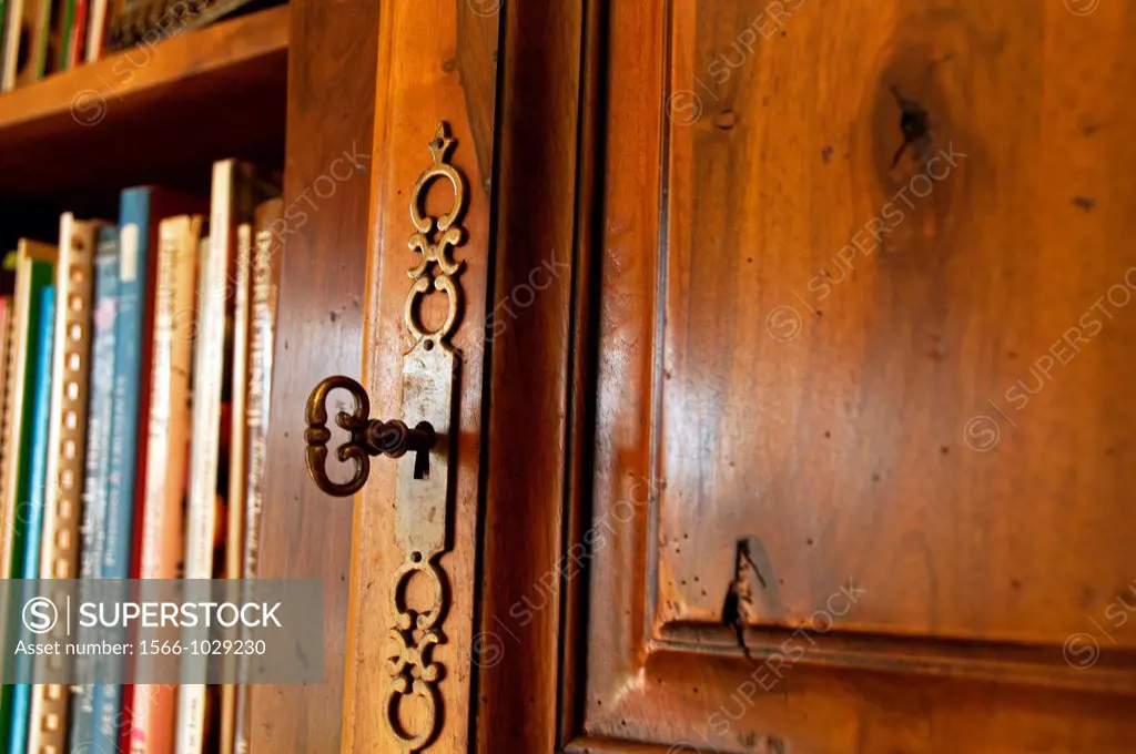 Wooden cabinet in French style - Louis Philippe, residential interior, close-up for decorative brass key