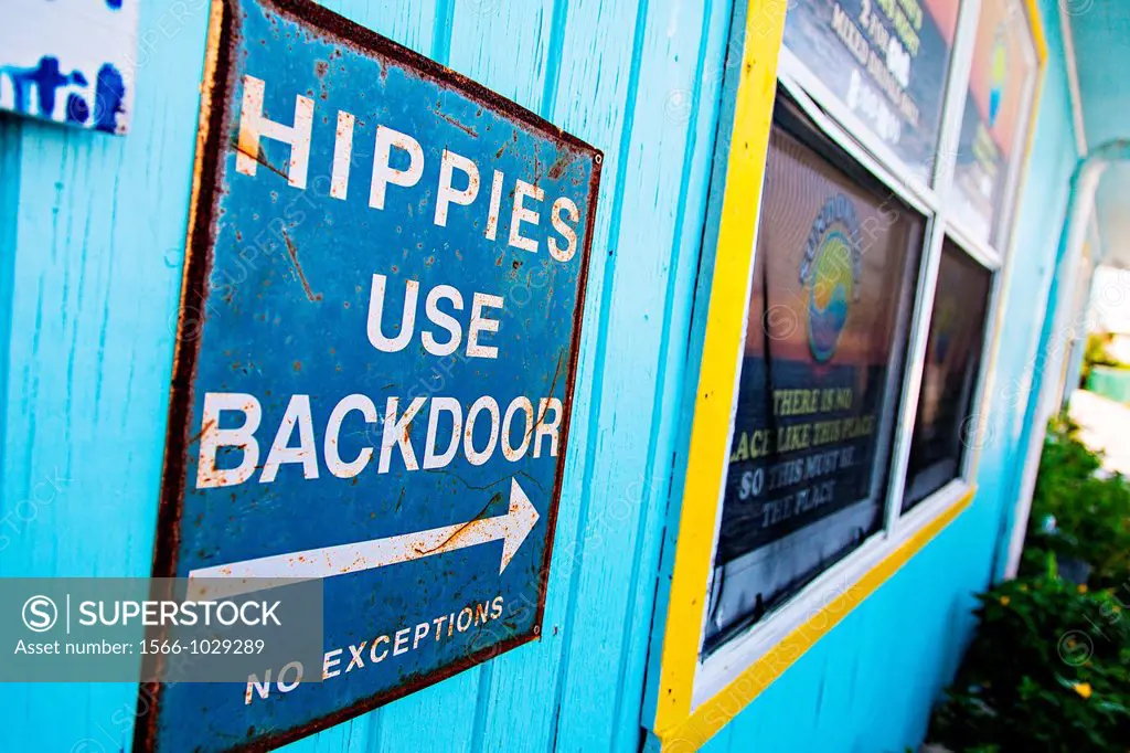 Old sign informing Hippies to use the backdoor at a bar on Green Turtle Cay, Bahamas