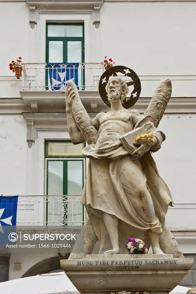 The fountain on piazza Duomo with the statue of Saint Andrew on top in the town of Amalfi on the Gulf of Salerno in southern Italy