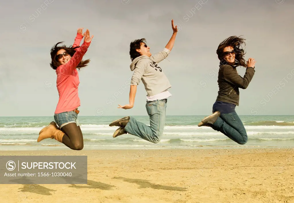 Girls jumping at the beach, in Valencia city, Comunidad Valenciana, Spain
