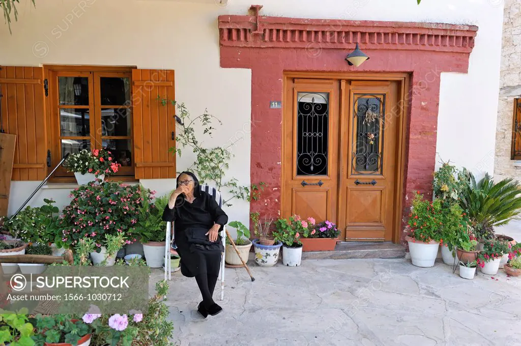 old woman black dressed in front of her home, Omodos, village in Troodos Mountains, Cyprus, Eastern Mediterranean Sea