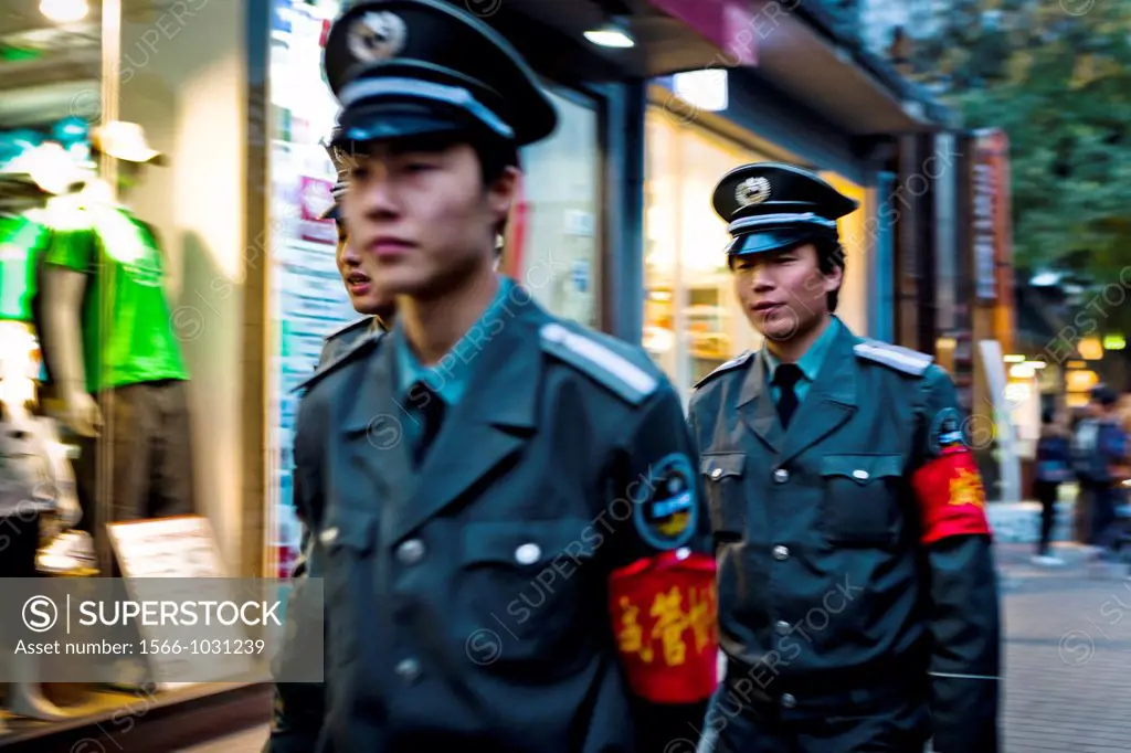 Chinese policemen, Nanlouguxiang Hutong, Beijing, China, Asia.