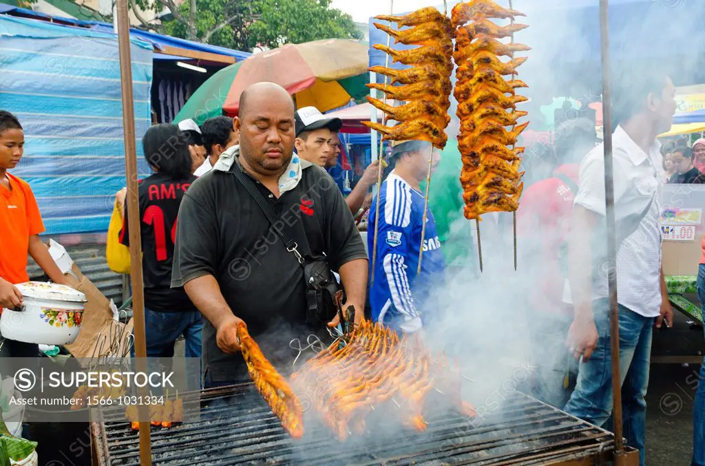 Roadside market stall, barbequed chicken on open grill, Sandakan, Sabah, East Malaysia