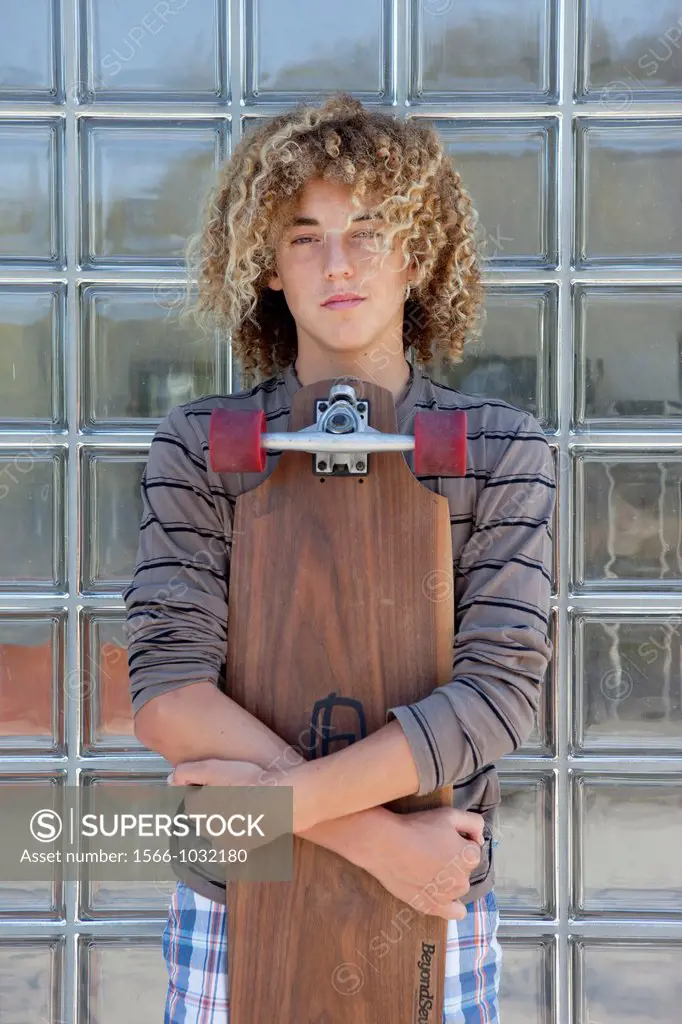 Teenage boy holding a long board