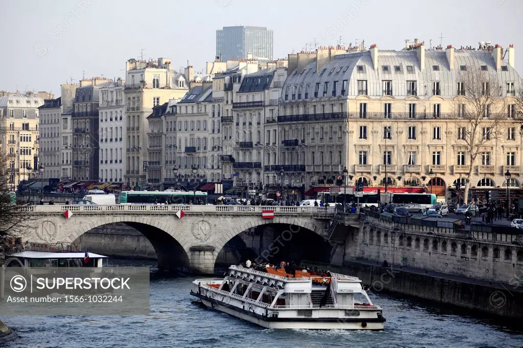 Tour boat in River Seine with the view of Saint-Michel Metro station area of Lift Bank in the background  Paris  France.