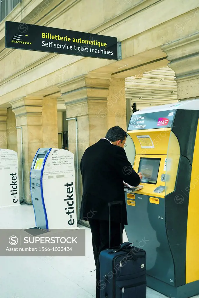 Paris, France- Gare du Nord Train Station, Man Buying Train Ticket from Vending Machine, Touch Screen Computer, inside, for Eurostar Train