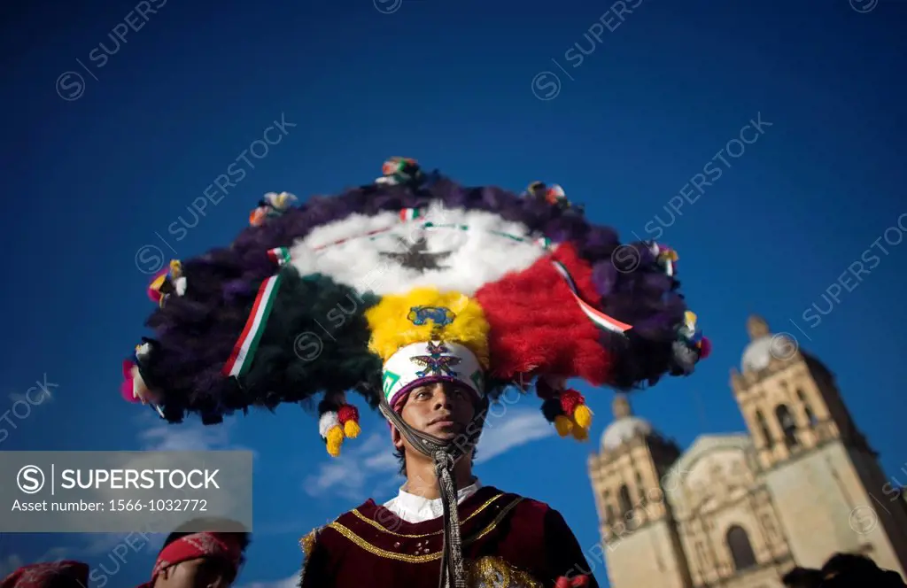 A dancer performs the Dance of the Feather or Danza de la Pluma during the Guelaguetza parade in front of the Santo Domingo church in Oaxaca, Mexico, ...