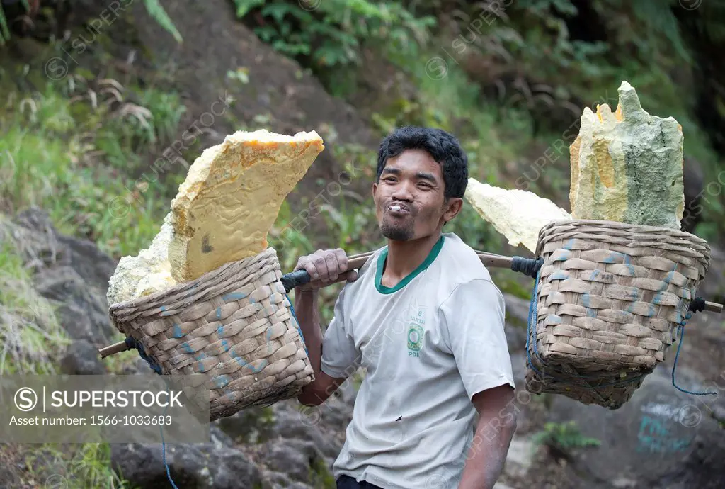 carrying out of the volcano mine sulfur by hand in Kawah Ijen, Java, Indonesia