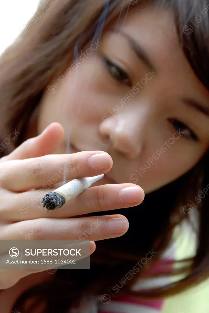 Intoxicated woman smoking a cannabis cigarette