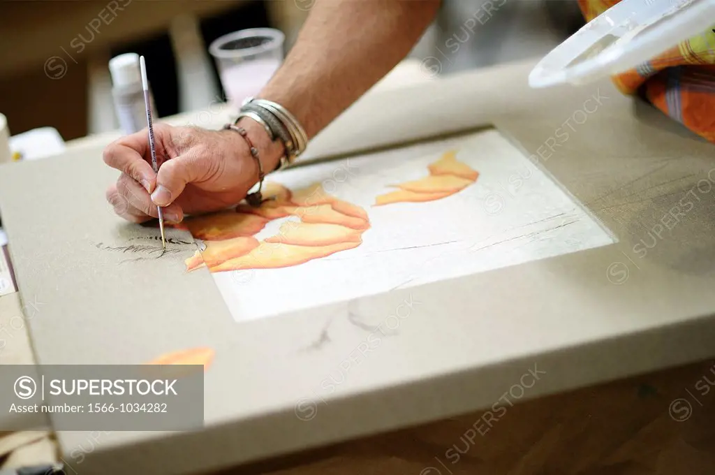 Artisan painting a frame