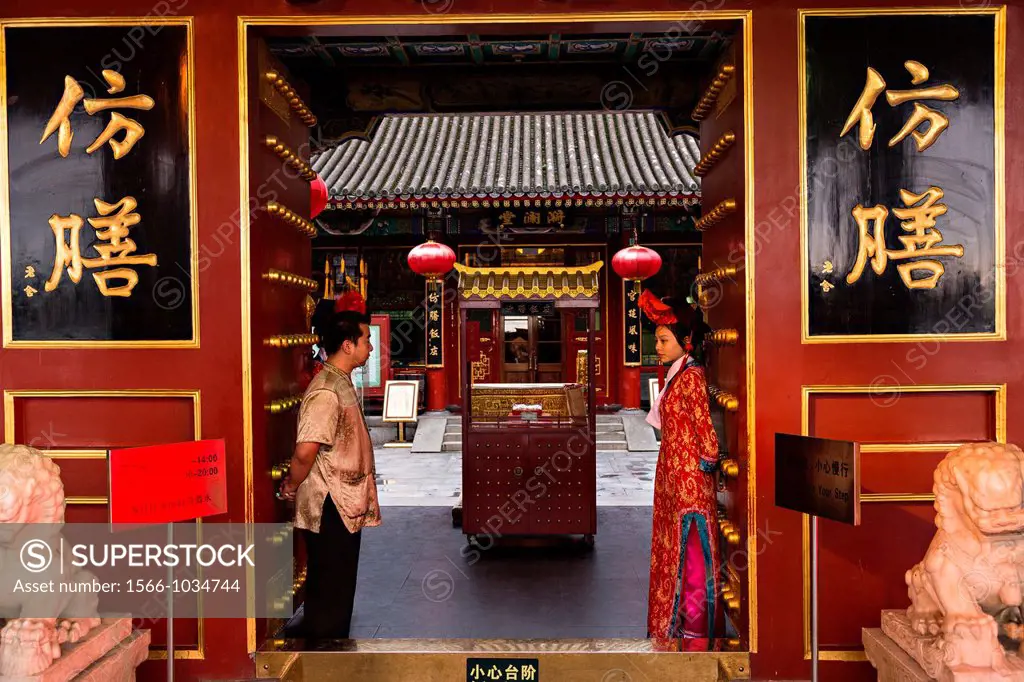 Dressed in traditional Chinese costume attendants at the Fangshan Imperial Restaurant welcome customers at Beihai Park in Beijing, China