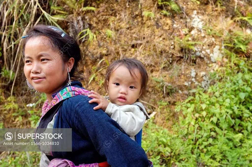 Black Hmong woman carrying baby on her back, Sapa, North Vietnam