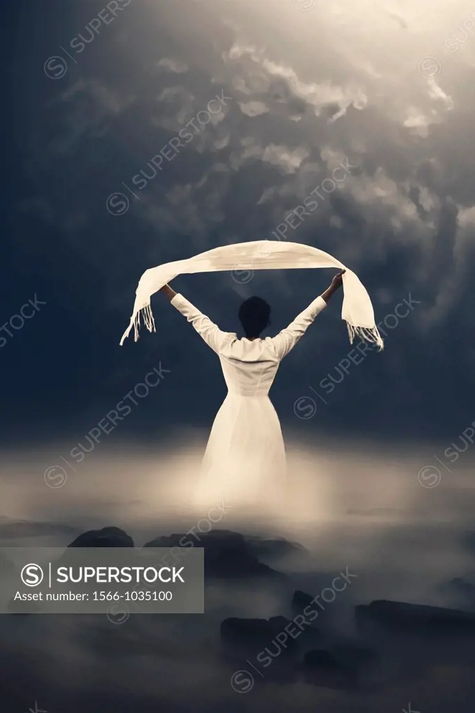 a woman in a white dress is coming out of the misty water