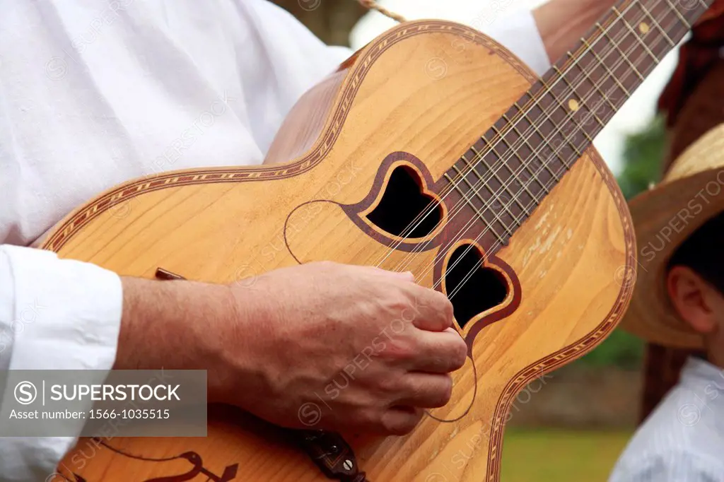 Man playing typical Azores islands guitar  Local portuguese name is ´viola da terra´