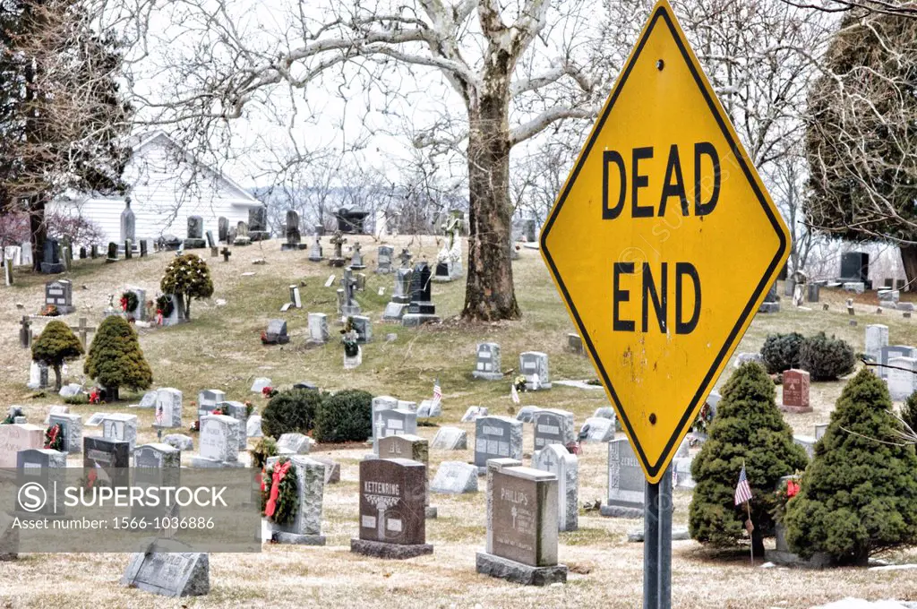 Dead End street sign with Grave yard ant tombstones in background, Croton, NY USA