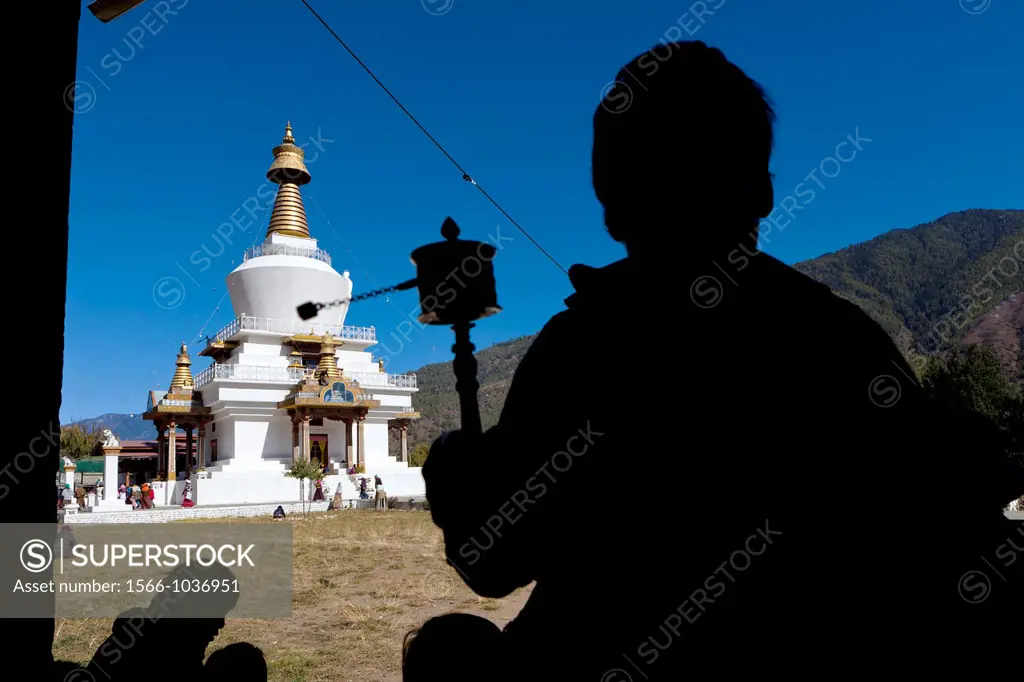 Bhutanese man holding a prayer wheel at Memorial Chorten, Thimphu, Bhutan, Asia.