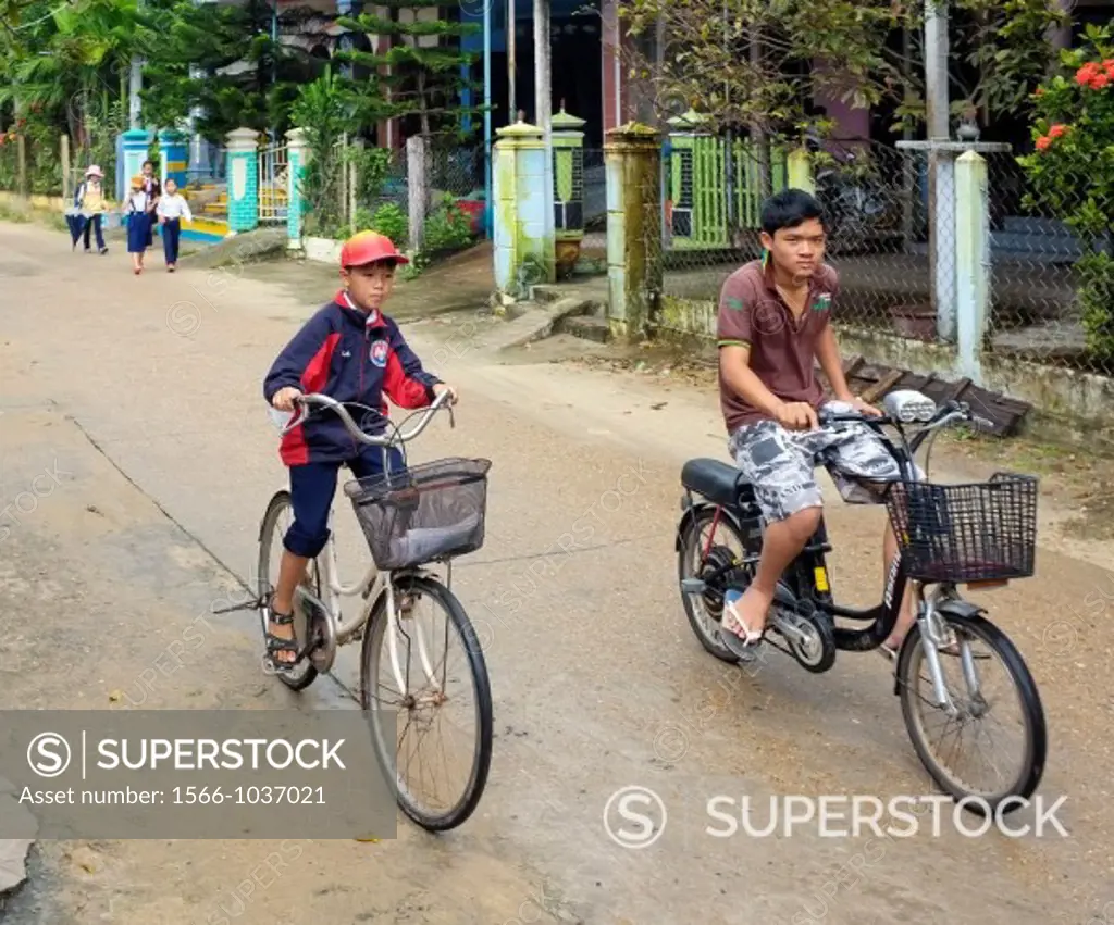 Schoolboys biking to school, Hoi An, Central Vietnam