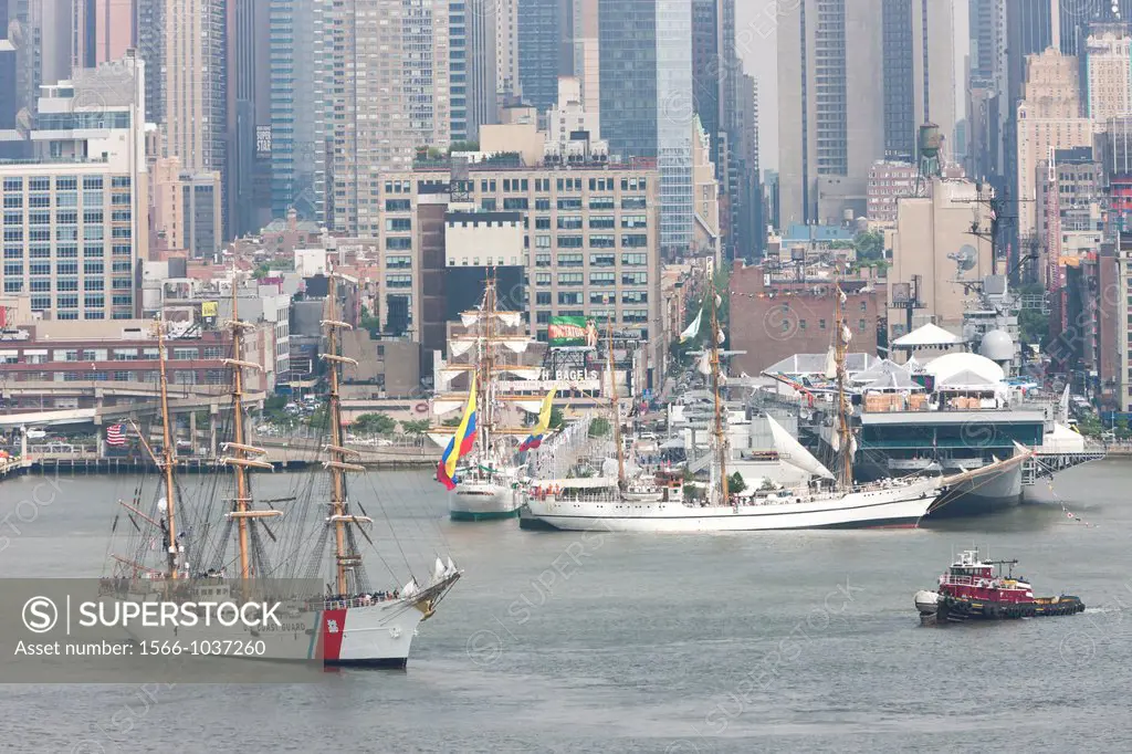 US Coast Guard Barque Eagle participates in the Parade of Sail on the Hudson River with other Tall Ships near the Intrepid Sea, Air, and Space Museum ...