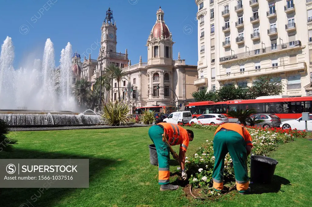 Valencia, Spain: gardeners at work in Plaza del Ayuntamiento