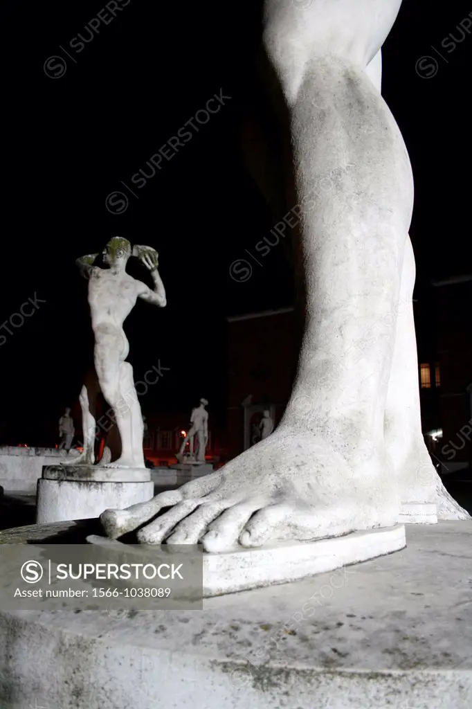 male statues at stadio dei marmi at night, rome