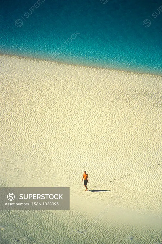 Solitary figure on the beach at Whitsunday Island, Queensland, Australia
