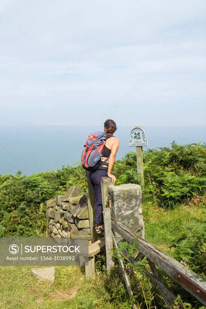 Female hiker near Loftus Alum Quarries on The Cleveland Way national trail coastal footpath near Staithes in North Yorkshire, England, United Kingdom
