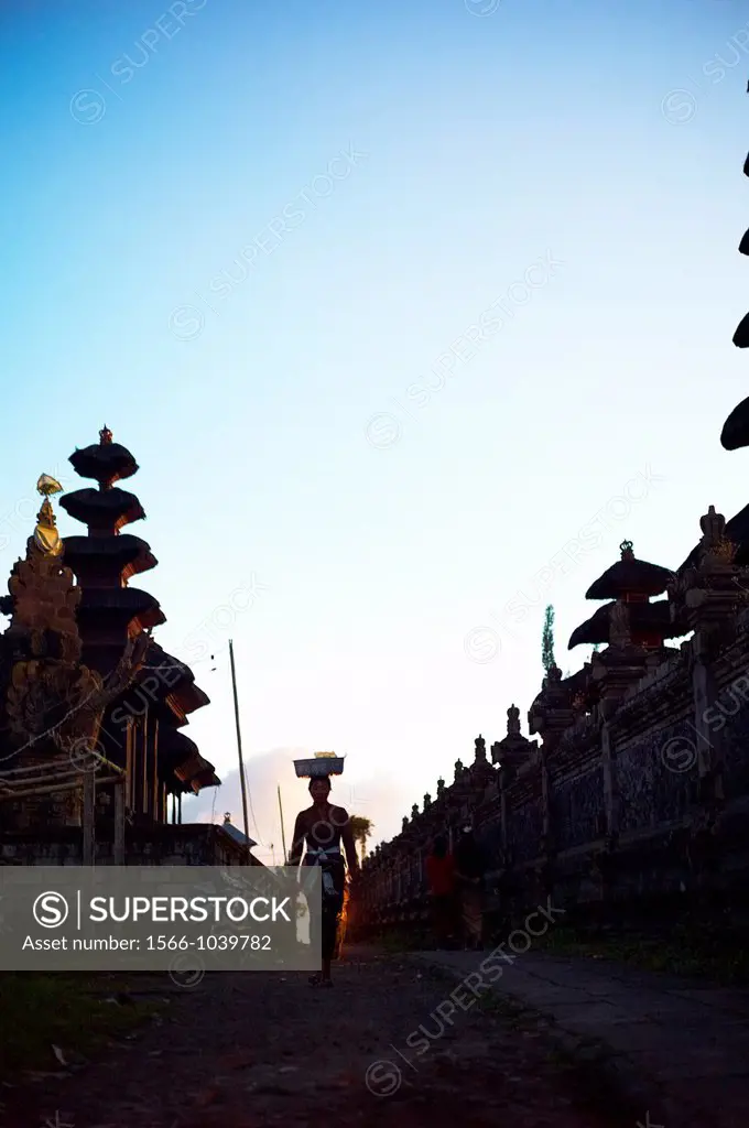 People carrying offering baskets on their head at The Ulun Danu Batur Temple on Mount Batur