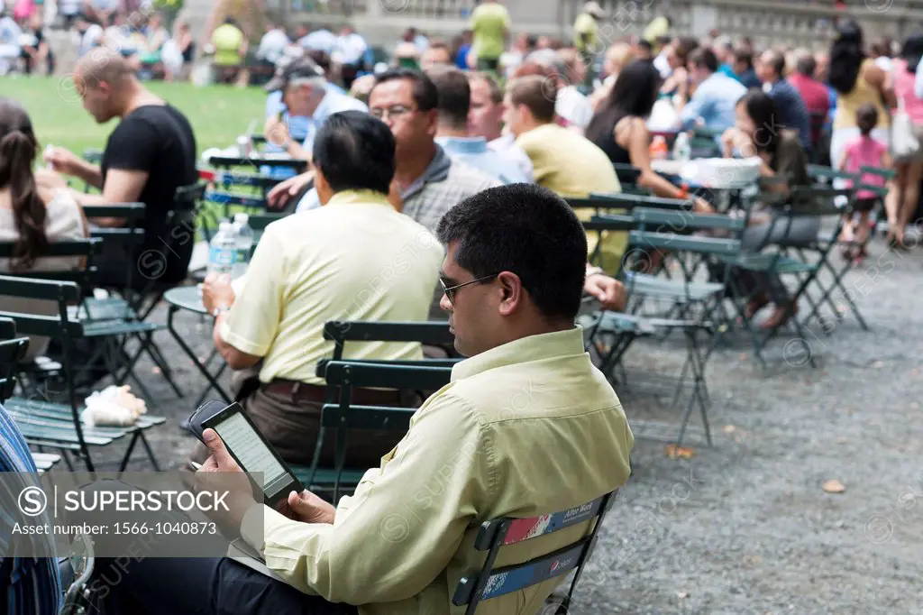 A reader uses his Sony ereader electronic book in Bryant Park in New York
