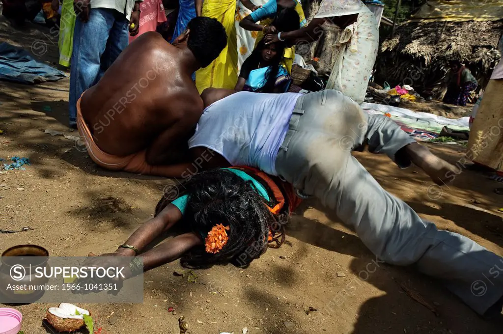 An exorcist practices evil spirit removal on a woman at Mel Malaiyanur temple  Mel Malaiyanur Melmalaiyanur, Gingee, Tamil Nadu, India.
