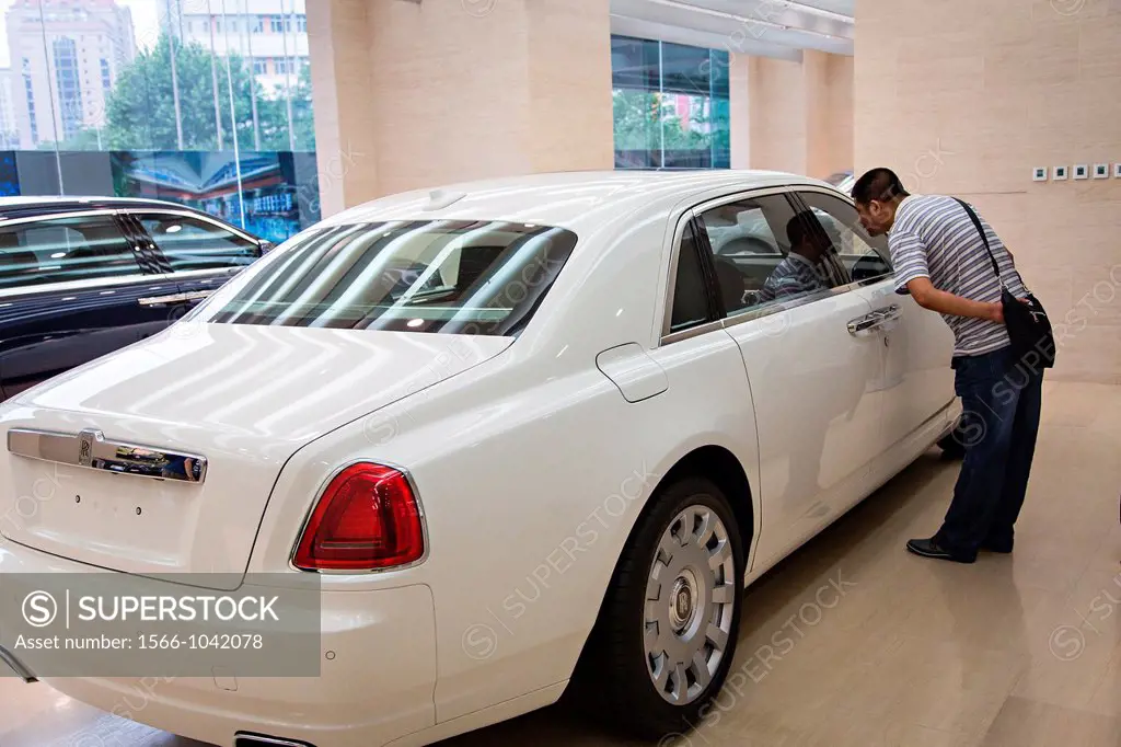 A Chinese millionaire shops for a Rolls Royce luxury car in Beijing, China