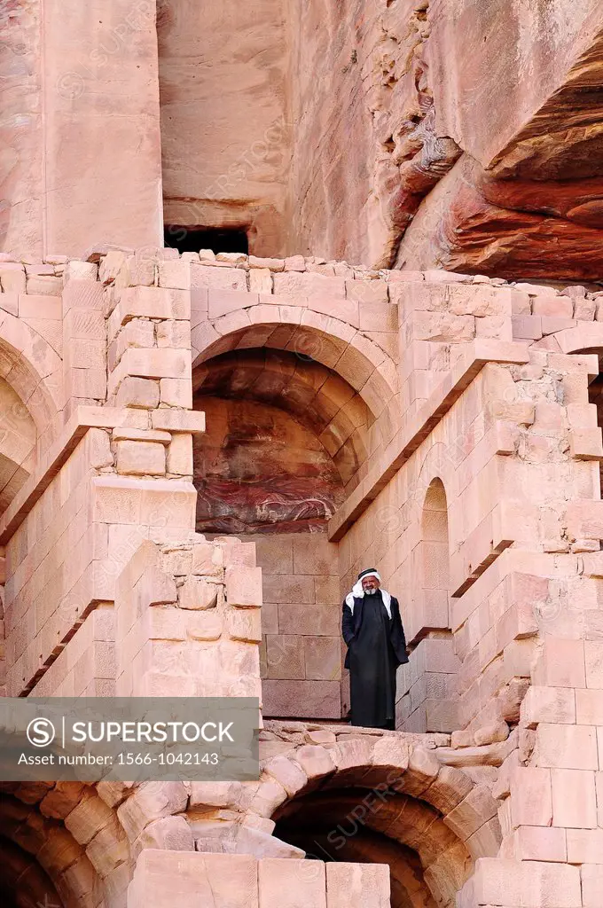 A beduin man standing in the Royal Tombs, Archaeological site, UNESCO World Heritage Site, Petra, Jordan, Middle East.