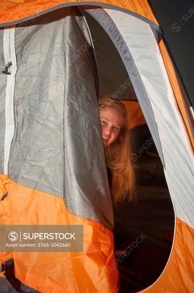 Young woman in camping tent