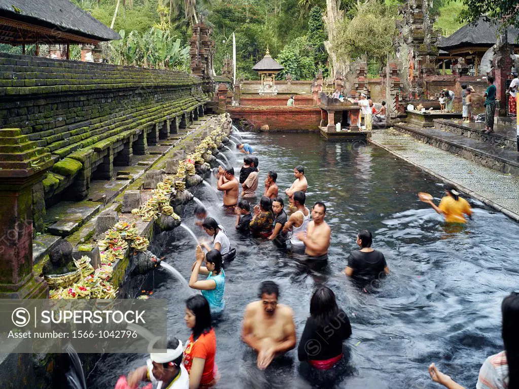 Balinese bath in the sacred waters of Tirta Empul  An ancient natural water spring feeds the baths  This area is believed to be the ancient center of ...