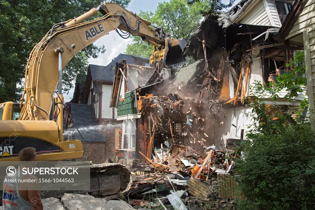 Detroit, Michigan - A fire-damaged and vacant home in the city´s Morningside neighborhood is demolished  Detroit´s population has crashed, from nearly...