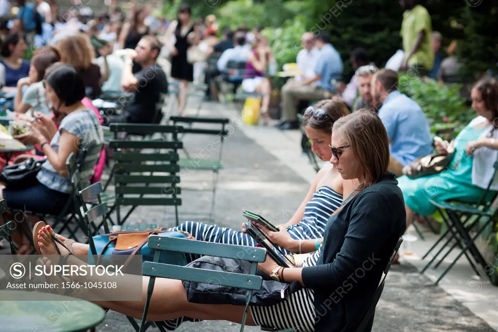 A readers use their iPad and Amazon Kindle in Bryant Park in New York