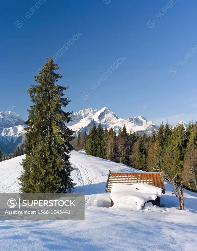 Wetterstein Mountain range in winter Sunrise over the peak of Alpspitze, the landmark of Garmisch-Partenkirchen, in the middle, Mount Zugspitze in the...