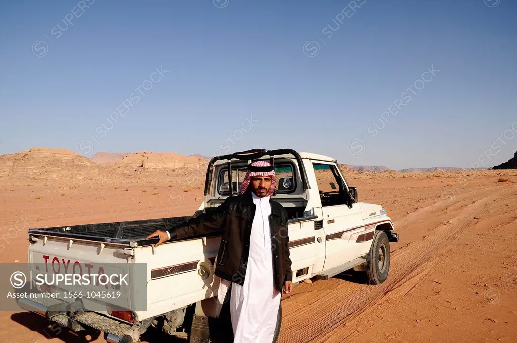 A beduin man with his 4x4 car, Wadi Rum desert, Jordan, Middle East.