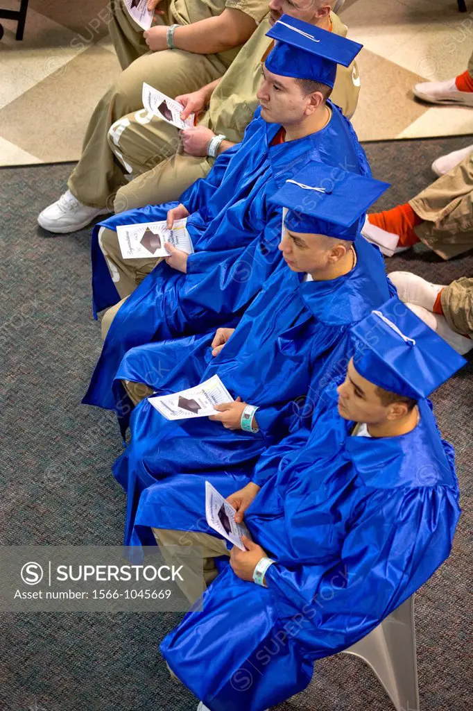 Wearing academic caps and gowns, three inmates are joined by their fellow multiracial prisoners in the city jail in Santa Ana, CA, for a graduation ce...